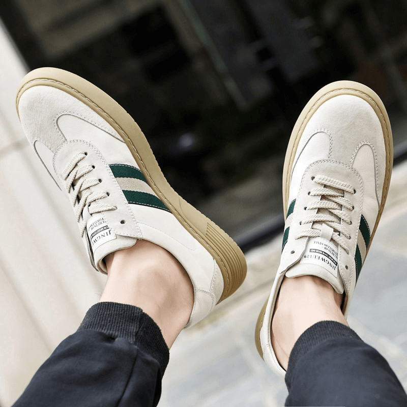 Man wearing stylish leather men's sports shoes SF1176 with breathable lining and rubber outsole, featuring a sleek design and solid pattern.